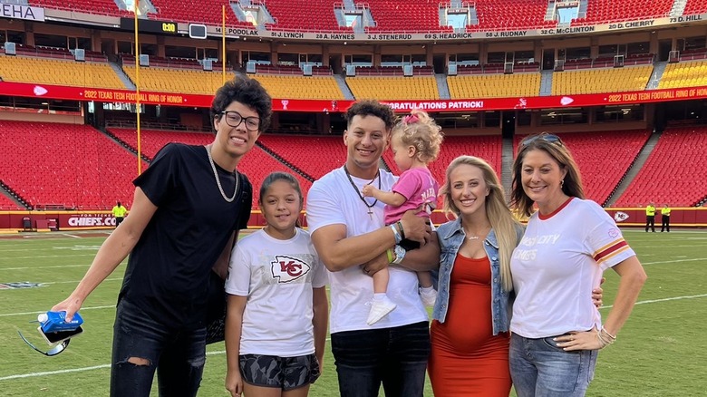 Brittany Mahomes, Patrick Mahomes, Randi Martin on football field