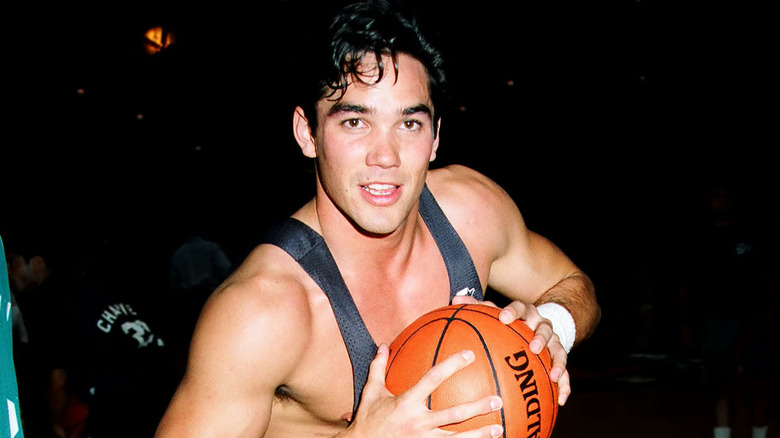 Young Dean Cain holding basketball 