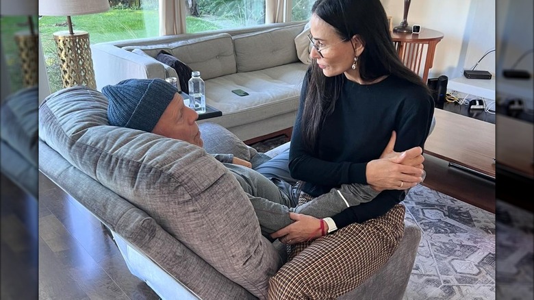 Demi Moore sitting on chair with Bruce Willis