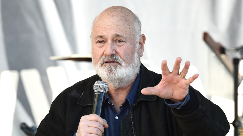 Rob Reiner holding microphone