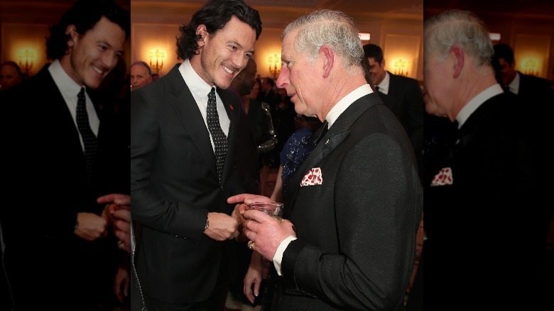 Luke Evans smiles as he talks with Charles