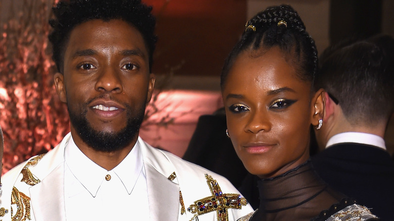 Letitia Wright and Chadwick Boseman posing 