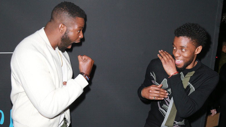 Winston Duke and Chadwick Boseman playfighting 