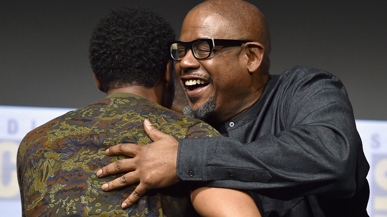 Forest Whitaker and Chadwick Boseman embracing 