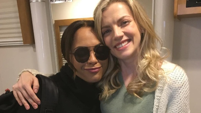 Kara Killmer posing with her arm around Monica Raymund