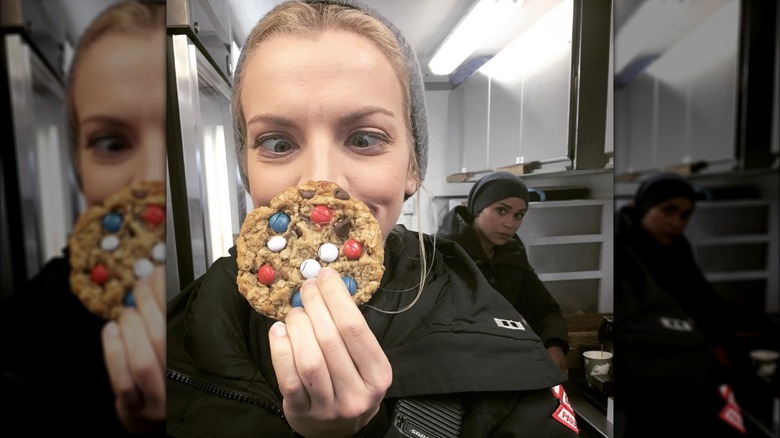 Kara Killmer poses with a cookie while Monica Raymund looks on in the background.