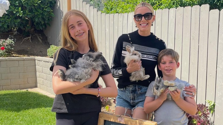 Heather, Brayden and Taylor El Moussa posing with bunnies