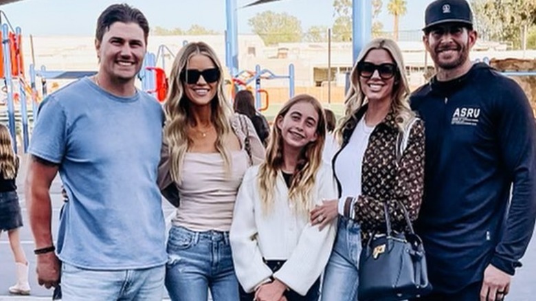 Christina Hall, Tarek El Moussa, their spouses and daughter posing