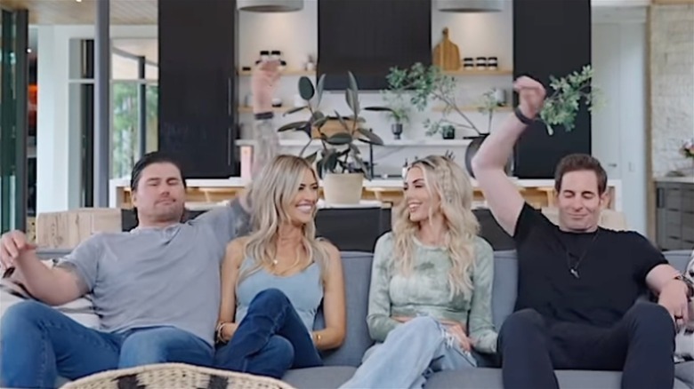 Christina and Josh Hall sitting on a couch with Tarek and Heather El Moussa