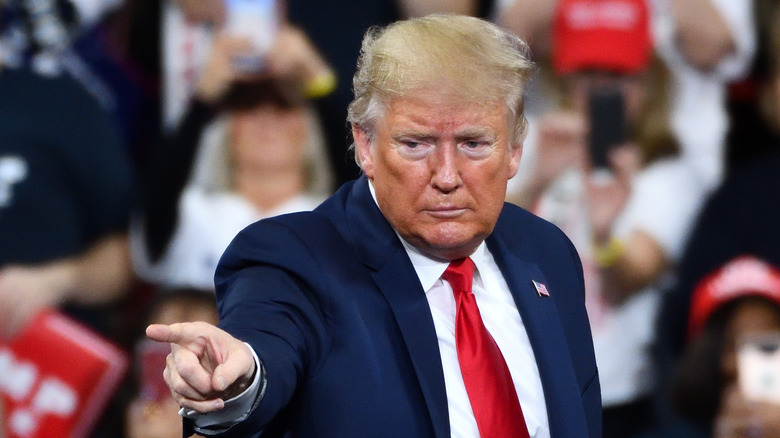 Former President Donald Trump points to audience at a campaign rally in 2019