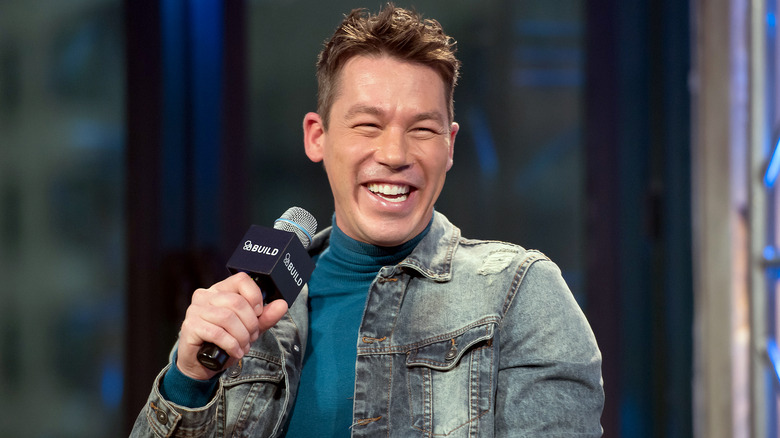 David Bromstad holding a microphone