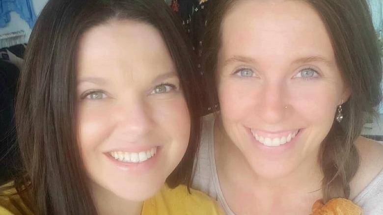 Amy Duggar and Jill Duggar pose together