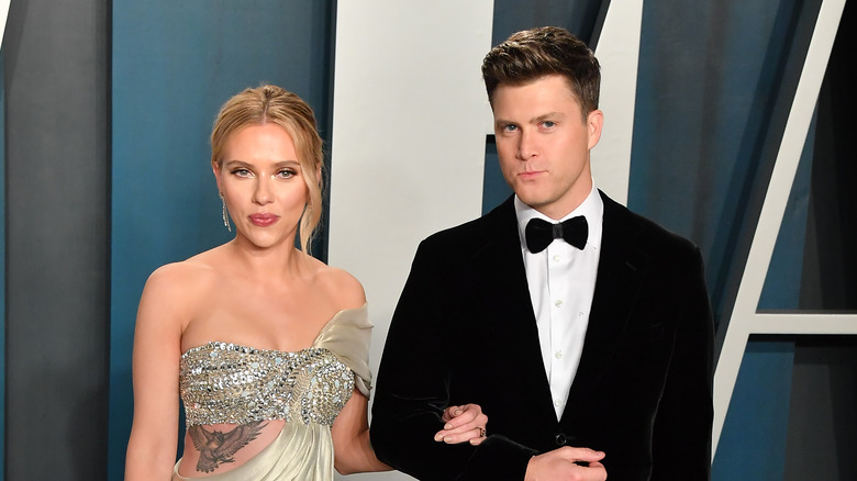 Scarlett Johansson and Colin Jost posing at an event