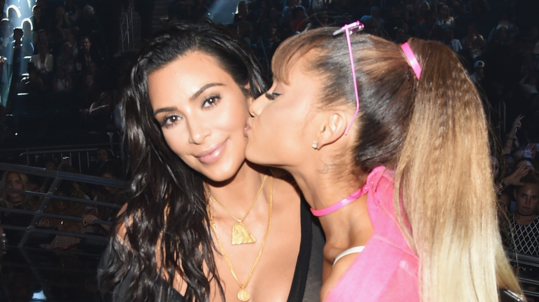 Ariana Grande kissing Kim Kardashian on the cheek