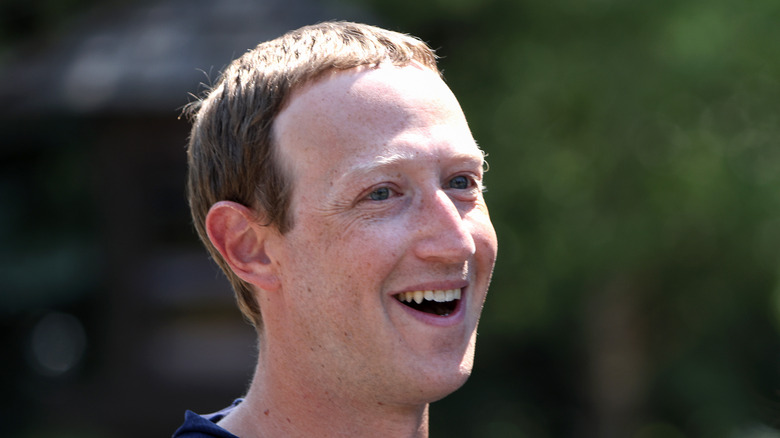 Mark Zuckerberg smiling and looking to the side