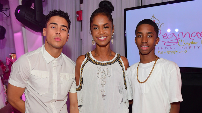 Kim Porter stands with Quincy Brown and Christian Combs