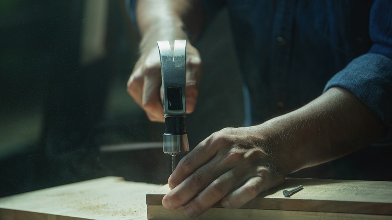 Man's hands with hammer