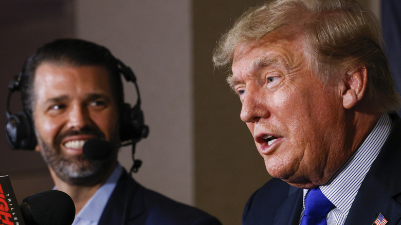 Former President Donald Trump speaks as Donald Trump Jr. looks on prior to the fight between Evander Holyfield and Vitor Belfort Sept 2021