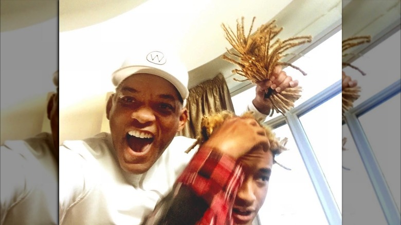 Will Smith holding Jaden Smith's old hair