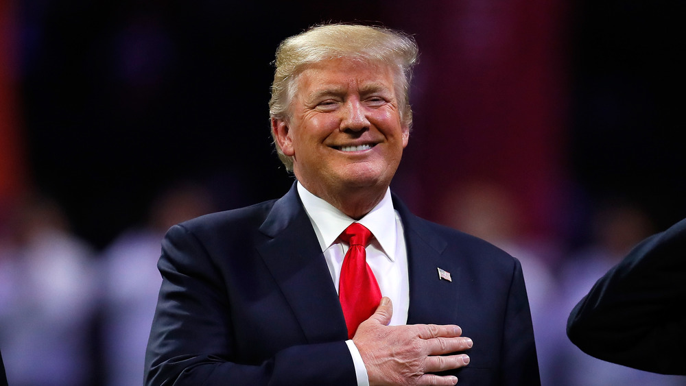 Donald Trump puts his hand on his heart while listening to the American anthem