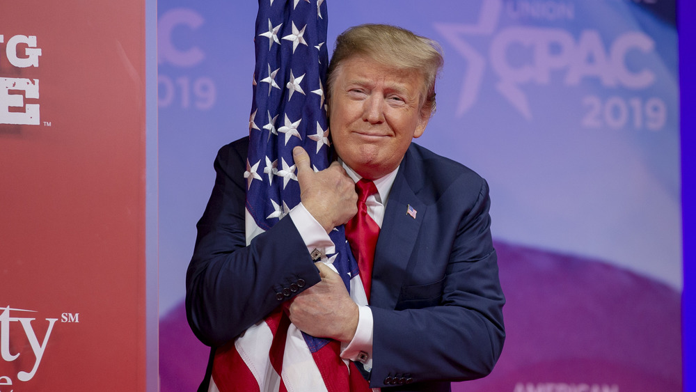 Donald Trump hugging the American Flag 
