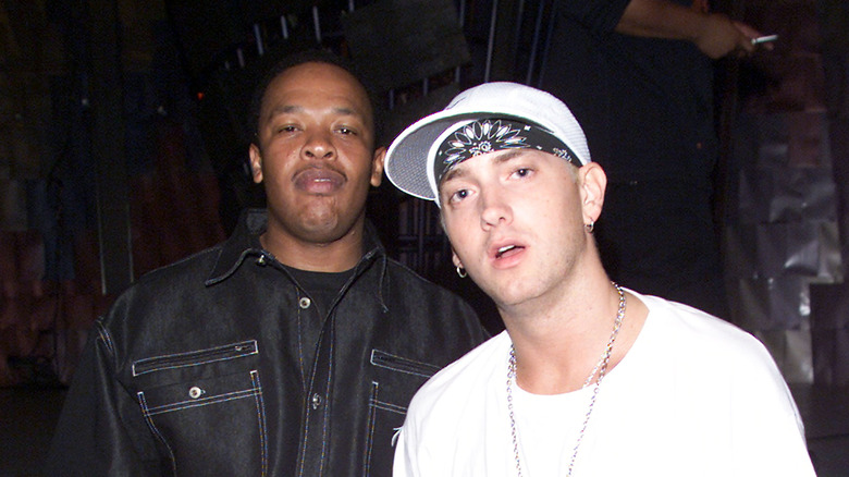 Dr. Dre wears a button down shirt and Eminem wears a white tee