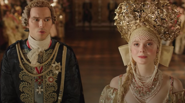 Nicholas Hoult wearing wig, Elle Fanning wearing gold headdress