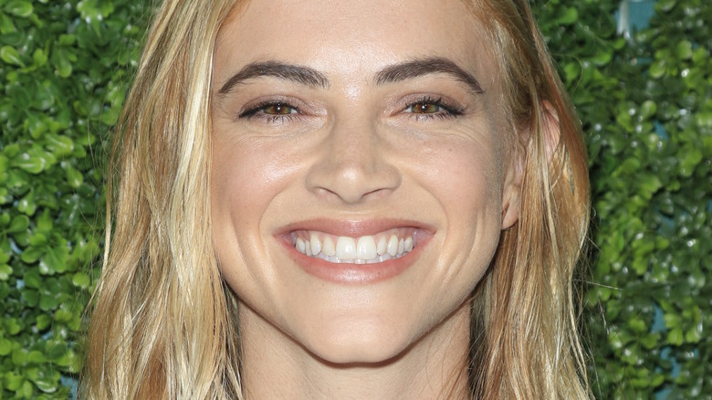 Emily Wickersham beams on the red carpet