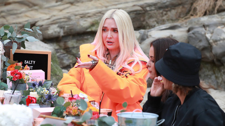 Erika Jayne in orange at the table