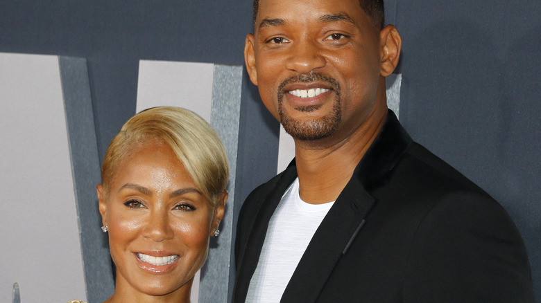 Will Smith and Jada Pinkett Smith smiling on the red carpet