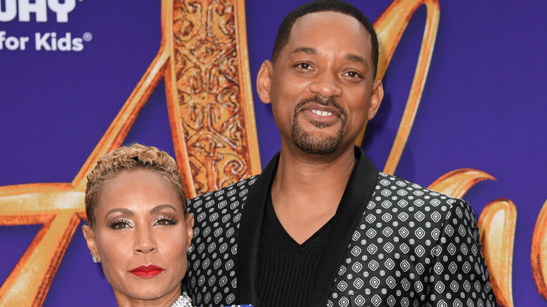 Will Smith and Jada Pinkett Smith smiling on the red carpet