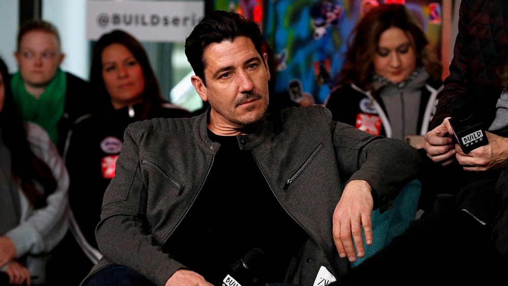 Jonathan Knight seated during interview