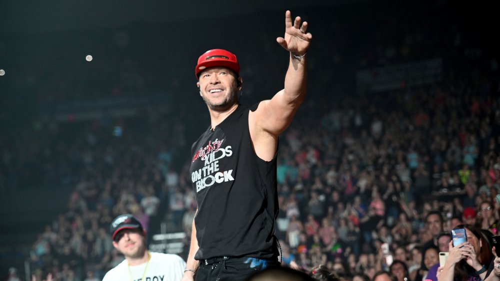 Donnie Wahlberg on stage waving at crowd