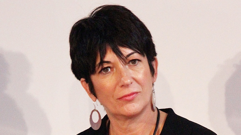 Ghislaine Maxwell head tilted earrings