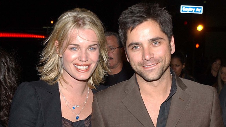 Rebecca Romijn and John Stamos grinning