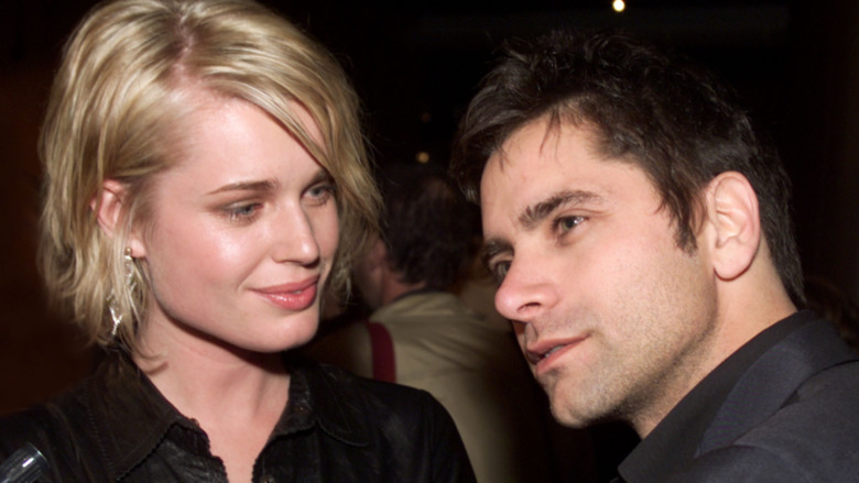 Rebecca Romijn and John Stamos at a movie premiere