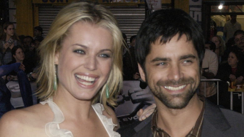 Rebecca Romijn and John Stamos at a movie premiere
