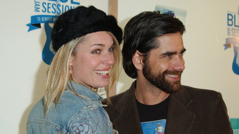 Rebecca Romijn and John Stamos grinning