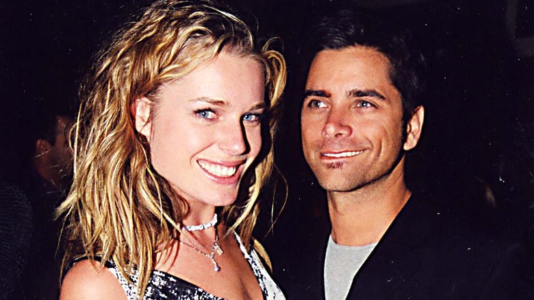 Rebecca Romijn and John Stamos grinning