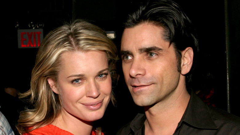 Rebecca Romijn and John Stamos smiling