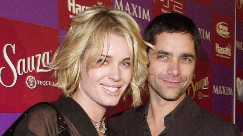 Rebecca Romijn and John Stamos smiling