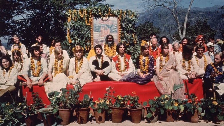 Several people, including the Beatles and Prudence Farrow, at the ashram