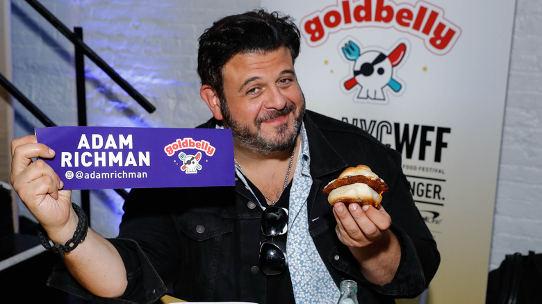 Adam Richman holding namecard