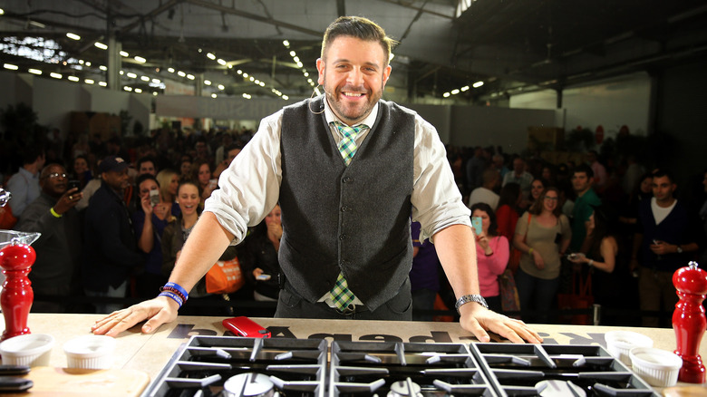 Adam Richman smiling at cooking event