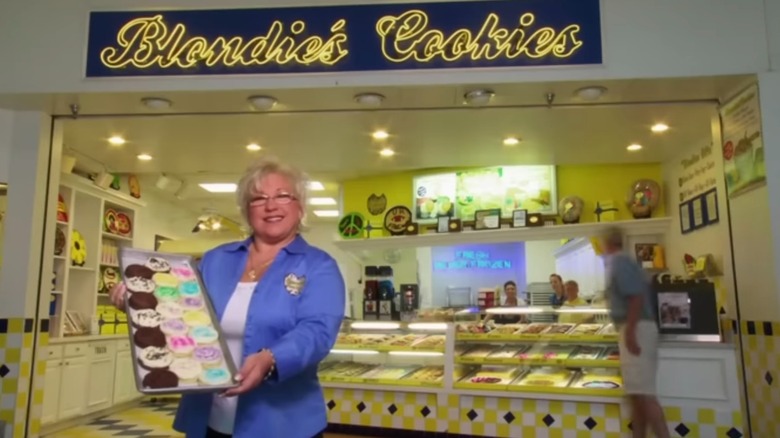 Brenda Coffman posing in front of store