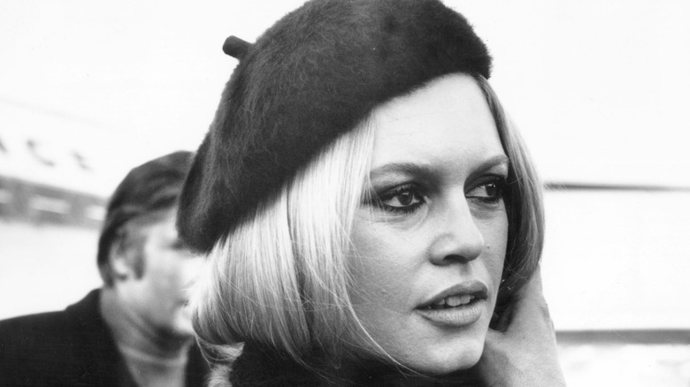 Brigitte Bardot in the 60s, with her hair tied back, wearing a beret