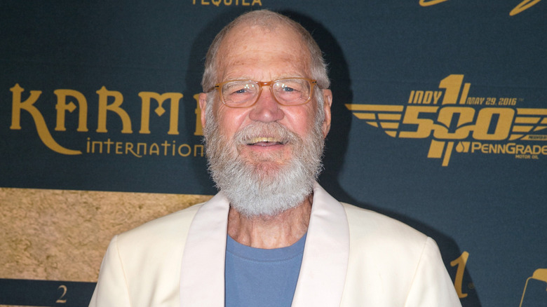 David Letterman smiling at an event with glasses and a white beard