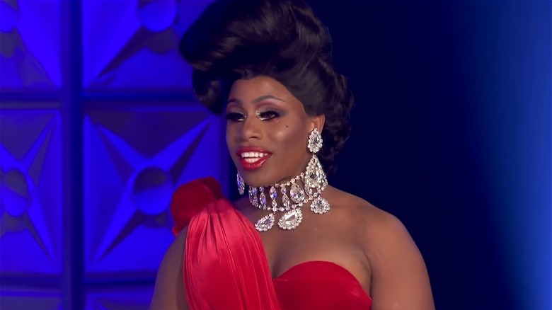 Monét X Change red dress diamond necklace big hair