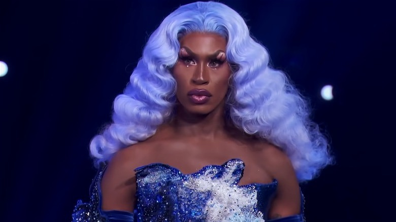 Shea Coulee blue hair and dress on runway