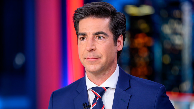 Jesse Watters wearing a suit on the set of his Fox News show